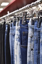 Jeans hanging on hanger in a store