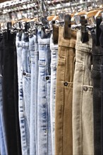 Jeans hanging on hanger in a store