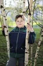 The Boy in the birch forest in early spring