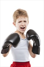 Smiling boxer child boy in boxing gloves training martial art sport white isolated