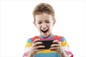 Little smiling child boy playing games or surfing internet on digital smartphone computer white