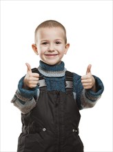 Little smiling child boy hands gesturing thumb up success sign