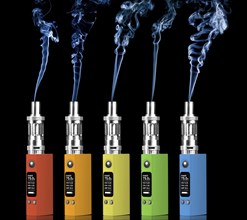 Five multicolored electronic cigarettes and steam, isolated on black background