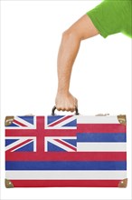 The Hawaii flag on a suitcase. Isolated on white