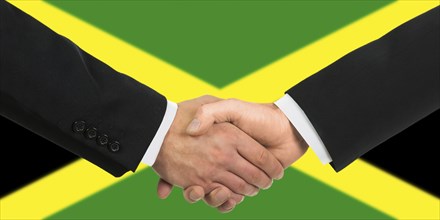 The Jamaica flag and business handshake