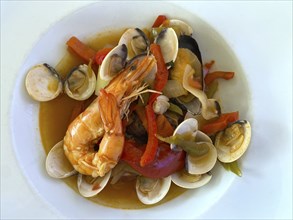 Portuguese fish stew Cataplana Algarvia on a plate, mussels, prawns, food, Algarve, Portugal,