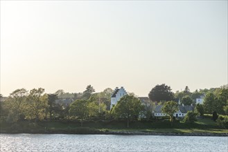 Svendborg, Sankt Jorgens Kirke at the Sund, whitewashed church, park, backlight, Fyn, Fyn Island,