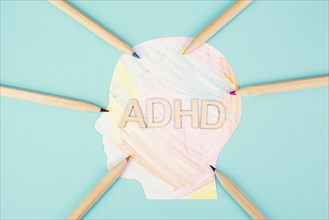 ADHD standing on a colorful head with pencils, attention deficit hyperactivity disorder, mental