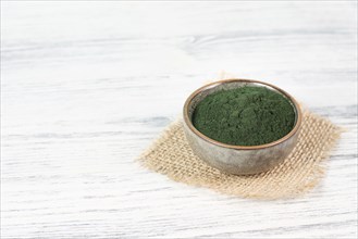 Spirulina algae powder in a bowl, alternative medicine for to detox, antioxidant food ingredients