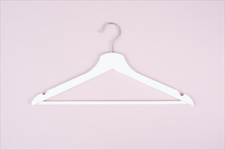 White hanger on a pink background, fashion store, minimalism clothes, discount promotion