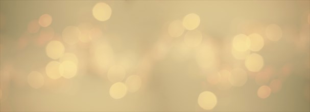 Bokeh background for christmas, defocused round lights in golden color, flare overlay