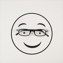 Head with a smiling face and eyeglasses, mental health concept, positive mindset, support and