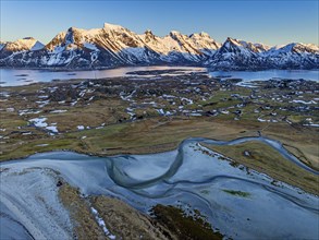 Aerial view of beach, village, steep mountains, coast, winter, evening light, Flakstadoya, Lofoten,