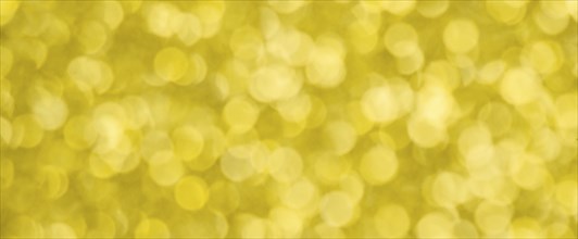 Golden bokeh background for christmas, defocused round lights and sunbeams, flare overlay