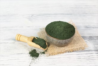 Spirulina algae powder in a bowl, alternative medicine for to detox, antioxidant food ingredients