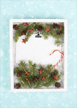 Christmas holiday background, frame with fir branches, stars, candy cane and pine cones, winter