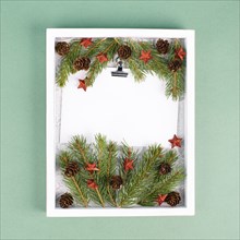 Christmas holiday background, frame with fir branches, stars, candy cane and pine cones, winter