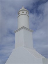 Lighthouse with a tower-shaped building under a cloudy sky in Lanzarote, arrecife, Lanzarote,