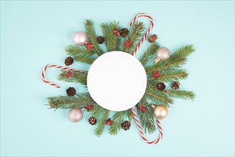 Christmas holiday background, frame with fir branches, baubles, candy cane and cones, winter season