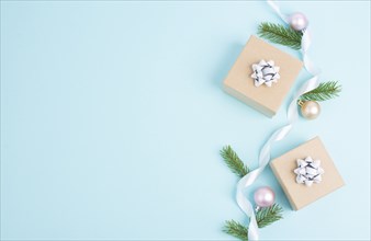 Christmas holiday greeting card with little gift boxes, baubles and fir branches, blue background