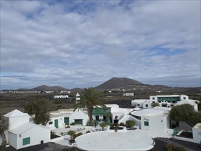 A village with white houses in a landscape surrounded by mountains, arrecife, Lanzarote, Canary