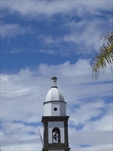 Close-up of a bell tower under a sky with scattered clouds, arrecife, Lanzarote, Canary Islands,