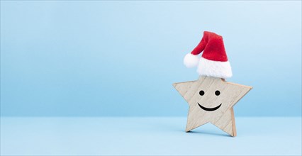 Star with a happy smiling face expression, red christmas hat, winter greeting card and banner, copy