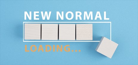 The words new normal are standing next to the loading bar, old and new life, time for a change