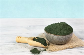 Spirulina algae powder in a bowl, alternative medicine for to detox, antioxidant food ingredients