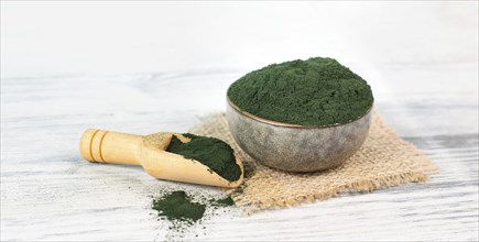 Spirulina algae powder in a bowl, alternative medicine for to detox, antioxidant food ingredients