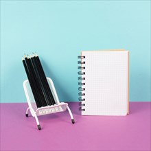 Empty notebook with pencils in a chair, being creative and brainstorming for new ideas, writing a