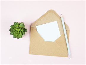 Envelope with an empty paper on a pastel colored background, copy space for text, greeting card,