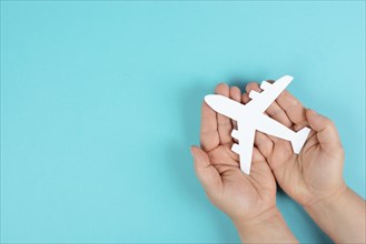Holding an airplane in the hands, taking a flight, planning a vacation
