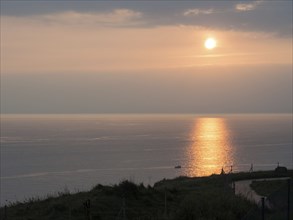 Romantic sunset by the sea with reflecting water surface, Heligoland, North Sea, Germany, Europe