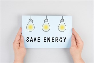 Save energy is standing on the paper, light bulbs, increase of electricity and gas costs,