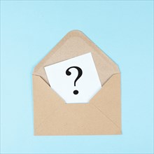 Question mark on a paper in an envelope, education and business concept, searching for answers,