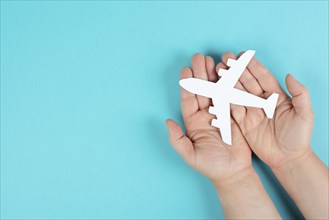 Holding an airplane in the hands, taking a flight, planning a vacation