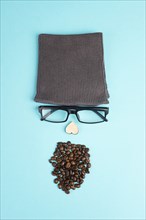 Human face made with a wool hat, glasses and coffee beans as a beard, funny minimalist portrait,