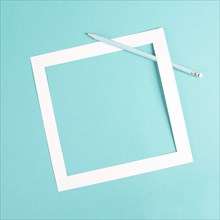 Pencil on a blue paper background, white frame with copy space for text, minimalism, creative and