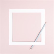 Pencil on a pink paper background, white frame with copy space for text, minimalism, creative and