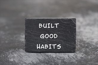 The words build good habits are standing on a blackboard, change lifestyle, healthy and positive