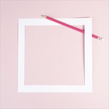 Pencil on a pink paper background, white frame with copy space for text, minimalism, creative and