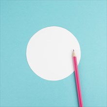 Pencils on a blue paper background, white circle frame with copy space for text, minimalism,