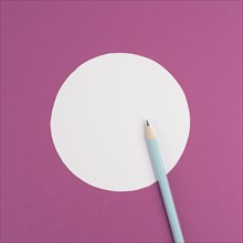 Pencils on a pink paper background, white circle frame with copy space for text, minimalism,