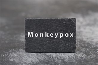 The word monkeypox is standing on a board, outbreak of the MPXV virus pandemic, infectious disease