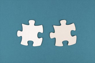 Two pieces of a puzzle, connecting together as a team, solving a problem, strategy and