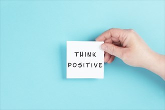 The words think positive are standing on a paper, optimistic mindset, coaching and motivation