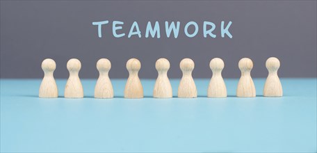 The word teamwork is standing over a group of people, working together as a team, corporation,