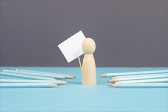 Man with an empty sign, blue pencils point to the person, business and education concept, cancel