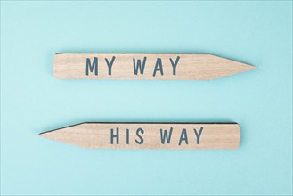 The words my way his way are standing on wooden arrows, christian religion faith, trust and believe